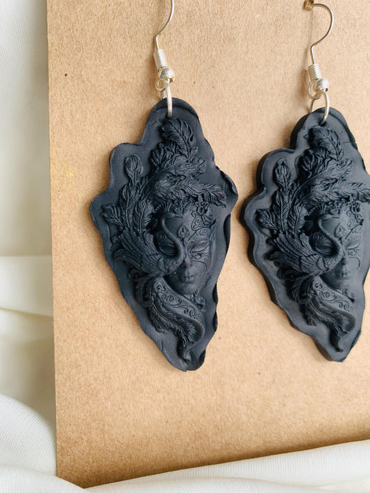Black masquerade masked face embossed dangle earrings