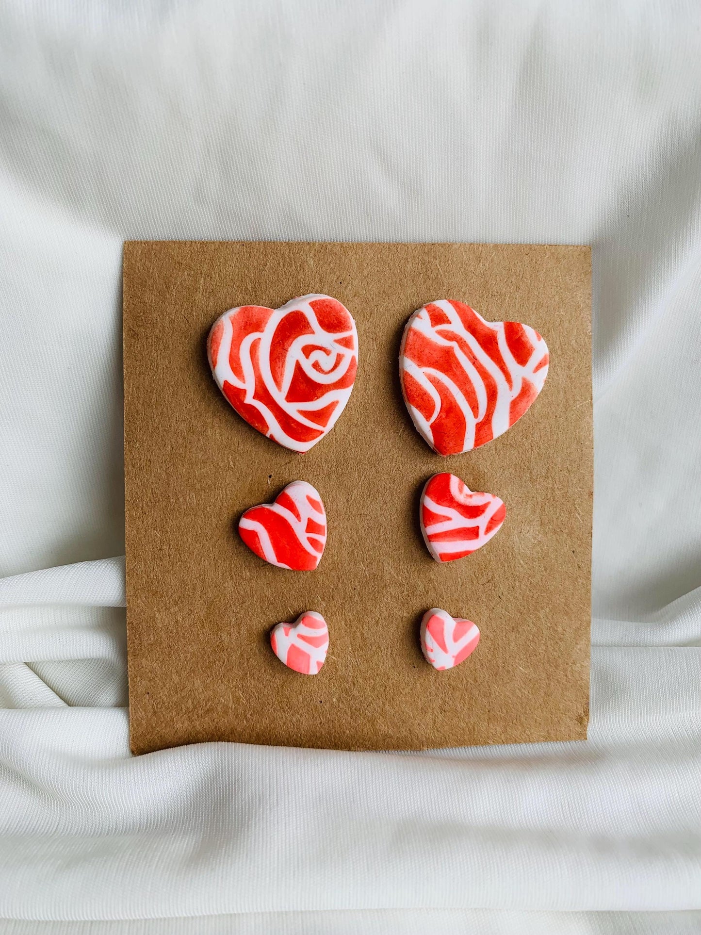 Rose pattern embossed in heart shaped stud earrings in three sizes and three colours