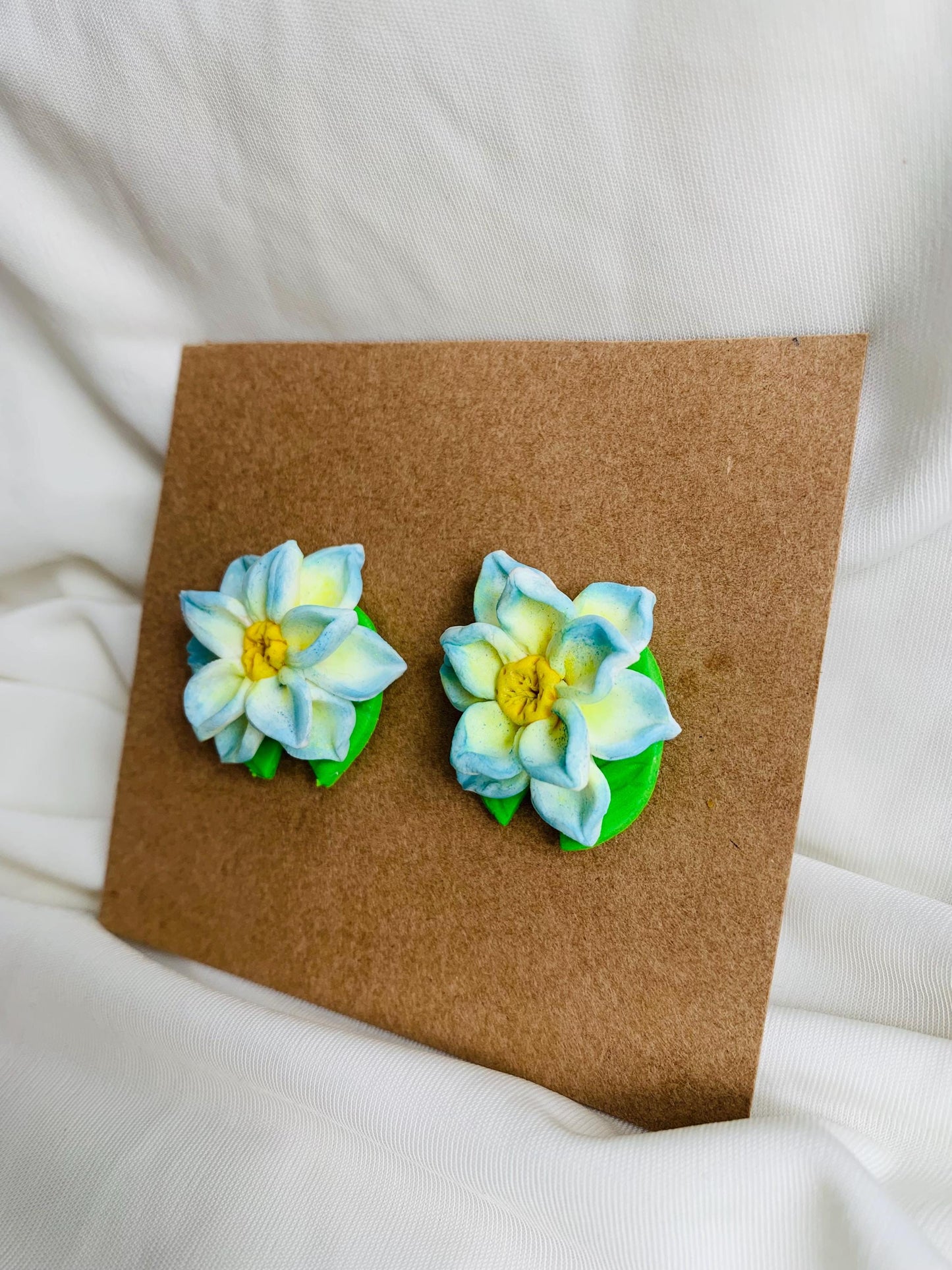 Blue lotus with a lotus leaf stud earrings