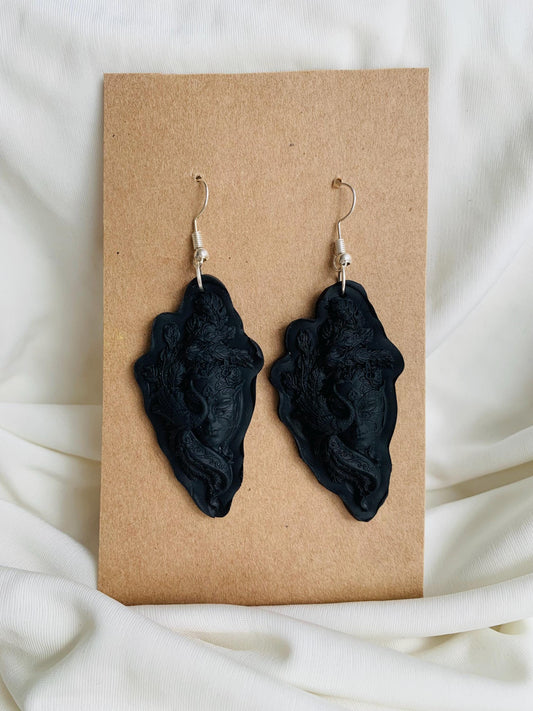 Black masquerade masked face embossed dangle earrings