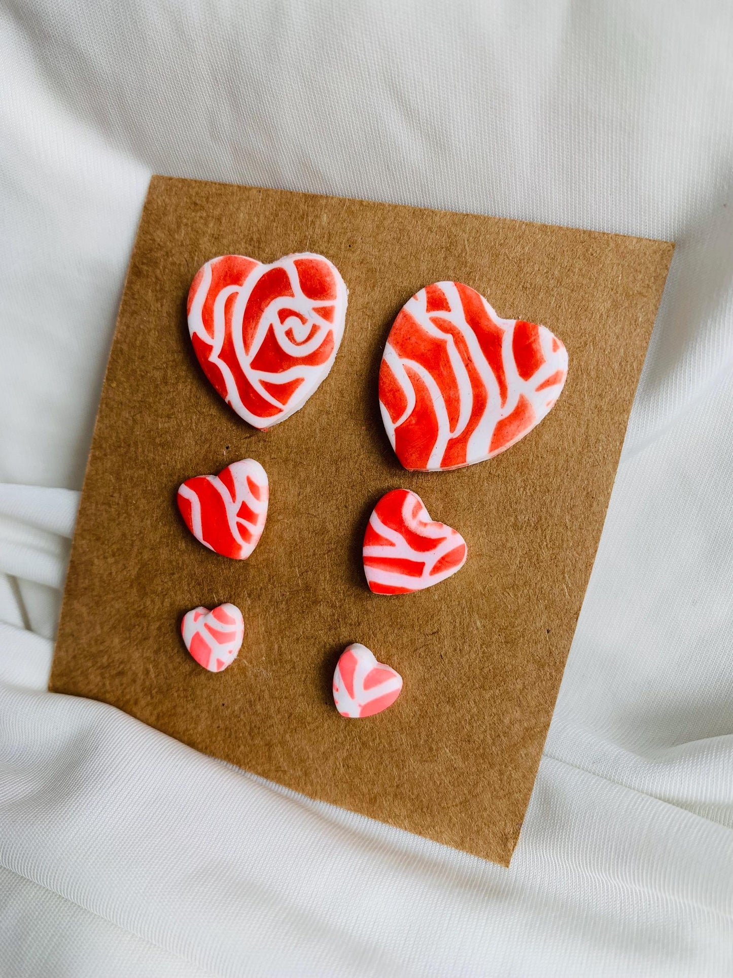 Rose pattern embossed in heart shaped stud earrings in three sizes and three colours